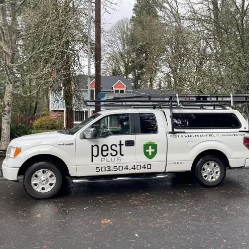 Pest Plus LLC service truck parked in front of a home in Multnomah County OR